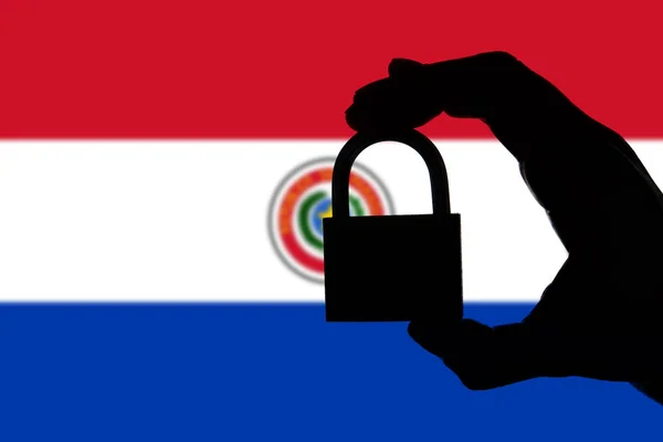 Paraguay security. Silhouette of hand holding a padlock over nat — Stock Photo, Image