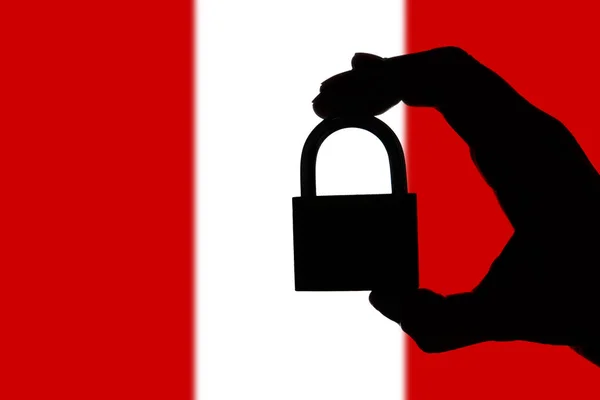 Peru security. Silhouette of hand holding a padlock over nationa — Stock Photo, Image