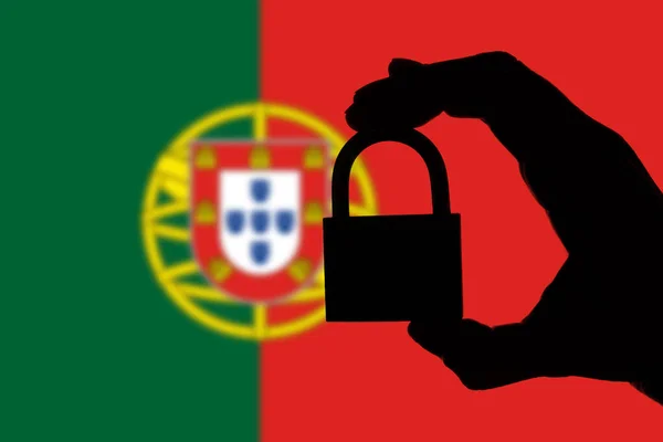 Portugal security. Silhouette of hand holding a padlock over nat — Stock Photo, Image