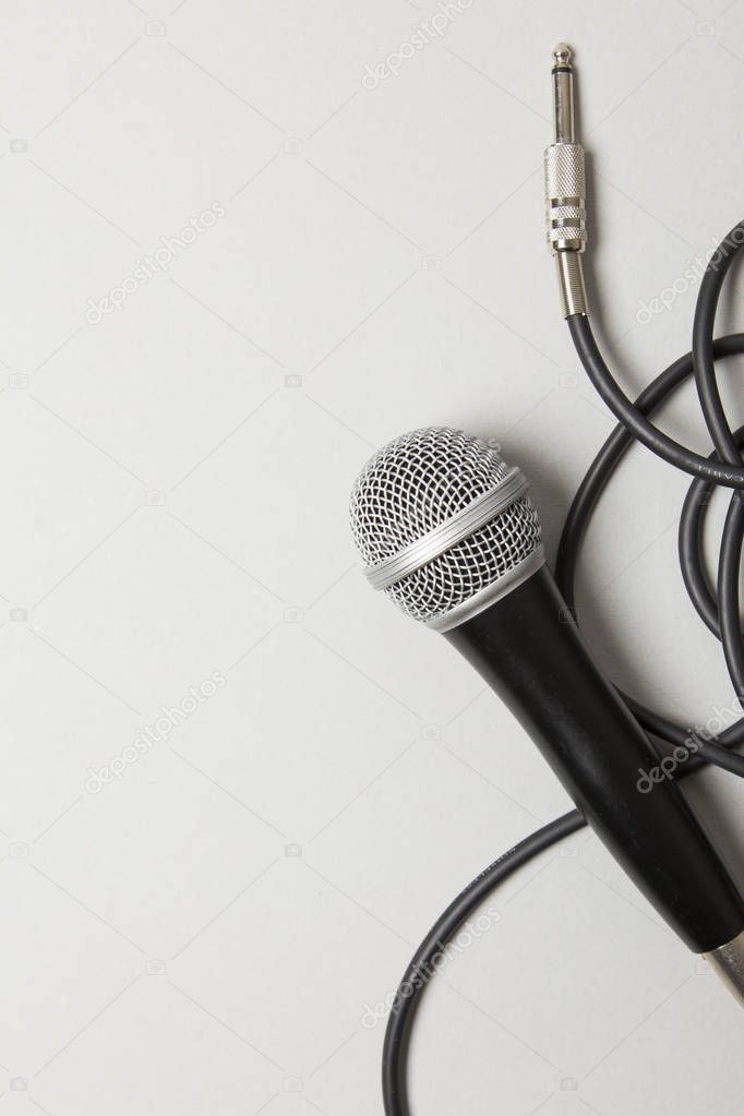 microphone and lead on a plain grey background.