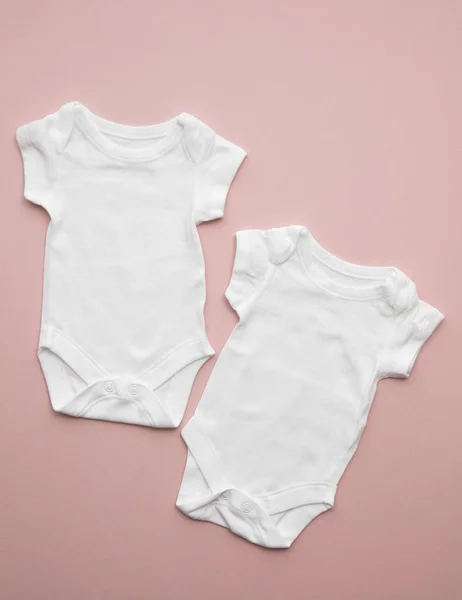 Cute baby white body suit layout on a pastel pink background — Stock Photo, Image