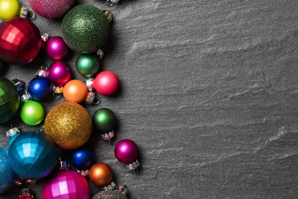 Festive Christmas baubles on a slate background — Stock Photo, Image