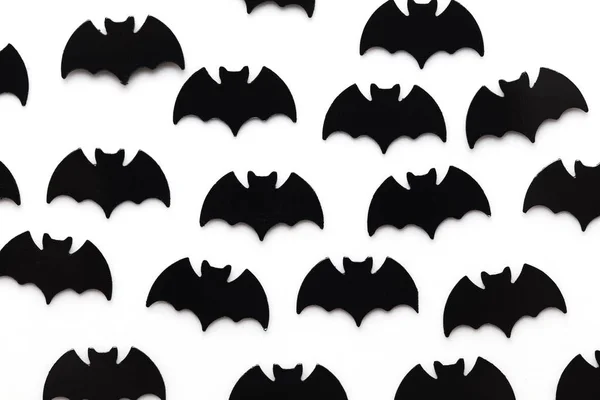 Black bat shapes on a white background. Halloween background — Stock Photo, Image