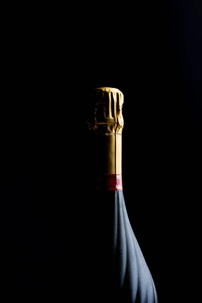 Botella de champán sobre fondo negro oscuro — Foto de Stock