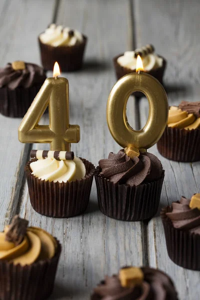 Number 40 celebration birthday cupcakes on a wooden background