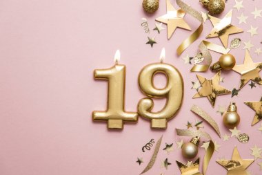 Yıldız ve ışıltılı arka plan üzerinde Sayı 19 altın kutlama mum