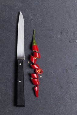 Kırmızı taze biber koyu bir kayrak backg üzerinde parçalar halinde doğranmış