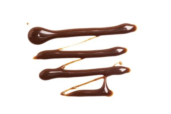 Csokoládé karamell szósz egy sima fehér backround — Stock Fotó