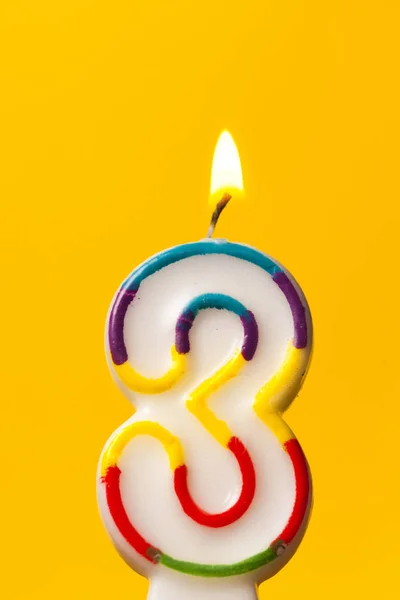Number 3 birthday celebration candle against a bright yellow bac — Stock Photo, Image