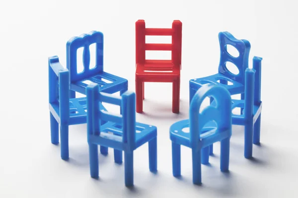 Circle of chairs with one odd one out. — Stock Photo, Image