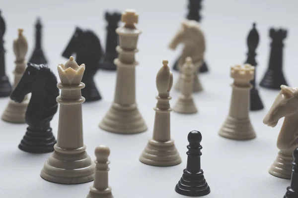 Chess game pieces on a grey background. Strategy concept