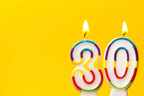 Bougie de célébration numéro 30 anniversaire contre une ba jaune vif — Photo