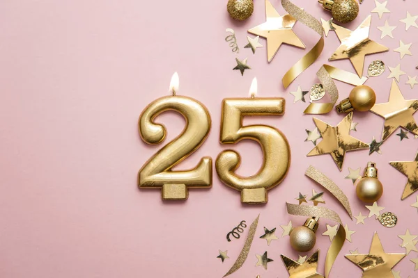 Number 25 gold celebration candle on star and glitter background — Stock Photo, Image