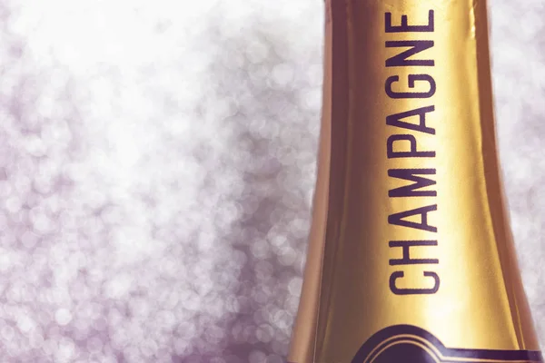 Champagne bottle on a sparkling glitter background — Stock Photo, Image