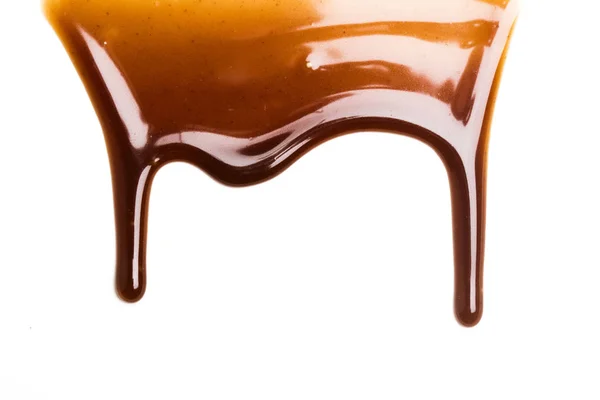 Chocolate caramel sauce drop on a plain white backround — Stock Photo, Image