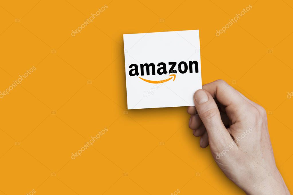 LONDON, UK - October 30th 2018: Hand holding Amazon logo. Amazon is the largest internet retailer in the world