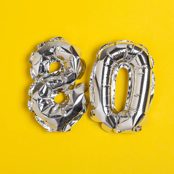 Srebrny folia numer 80 celebracja balon na jasnym żółtym BAC — Zdjęcie stockowe