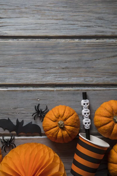 Halloween party decorations on a rustic wooden background