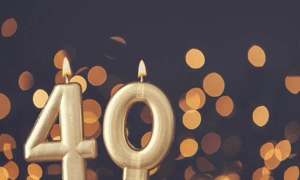 Gold number 40 celebration candle against blurred light backgrou — Stock Photo, Image