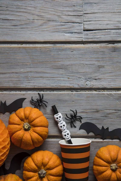 Halloween party decorations on a rustic wooden background