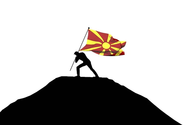 Bandeira da Macedônia sendo empurrada para o topo da montanha por uma silhueta masculina — Fotografia de Stock