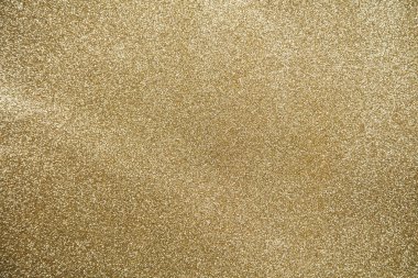 Altın parıltılı arka plan üzerinde Altın yıldız ışıltı parti konfeti