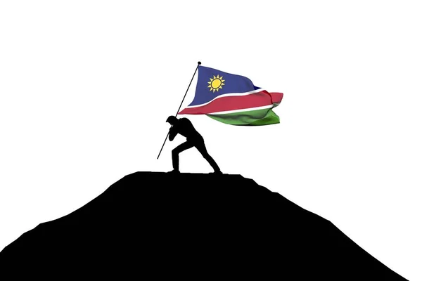 Namibia bandiera spinta in cima alla montagna da una silhouette maschile — Foto Stock