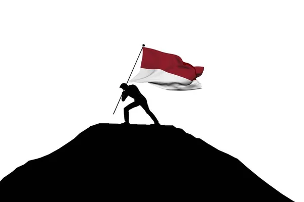 Indonesië vlag wordt geduwd in Mountain Top door een man silhouet — Stockfoto