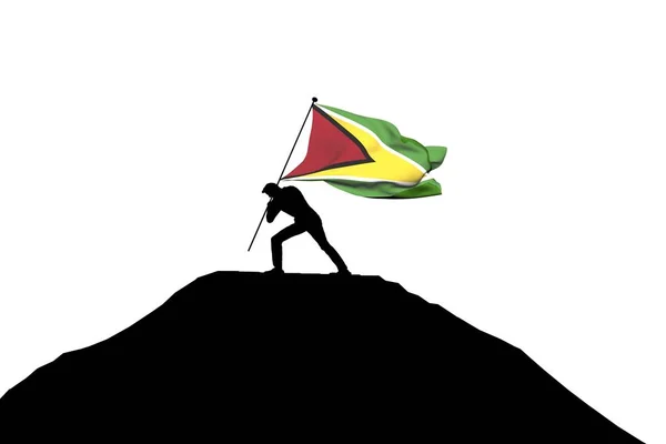 Bandera de Guyana siendo empujada a la cima de la montaña por una silueta masculina . —  Fotos de Stock