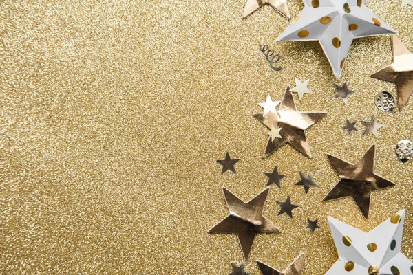 Gold star sparkle party confetti on a gold glitter background — Stock Photo, Image