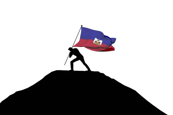 Haitianische Flagge wird von einer männlichen Silhouette in den Berggipfel gedrückt. — Stockfoto