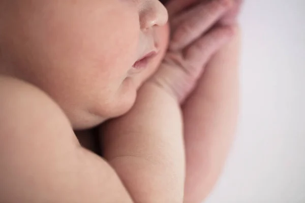 Close up of a cute sleeping baby resting on their arms — Stock Photo, Image