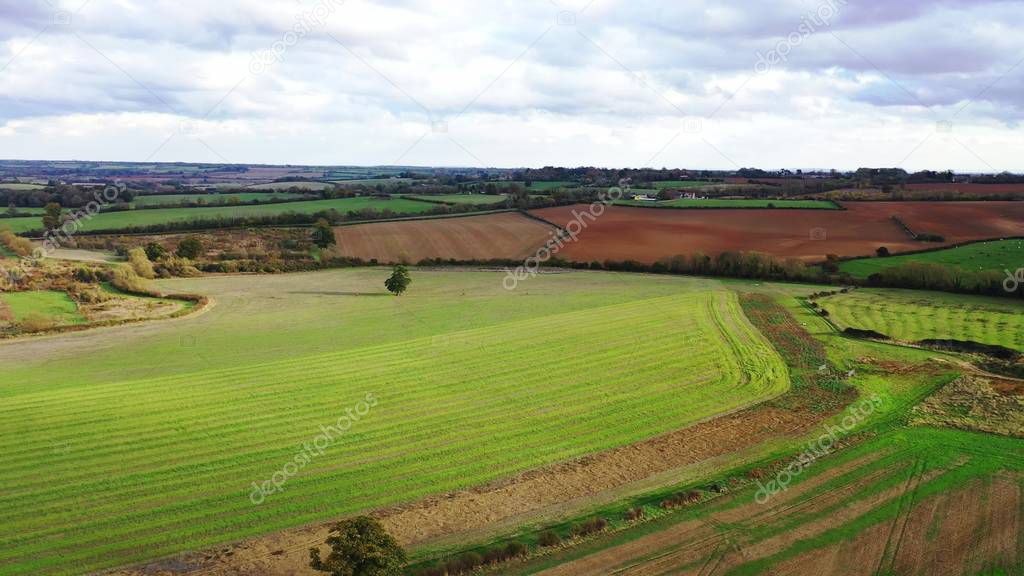 Drone flight over green countryside fields in the UK 