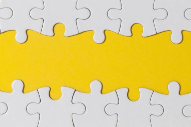 White jigsaw puzzle pieces on a yellow background. Business solu clipart