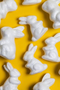 Parlak sarı arka planda Paskalya tavşanları