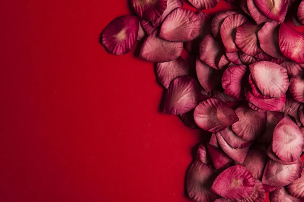 Red rose petals on a red background. Romantic valentines day bac — Stock Photo, Image
