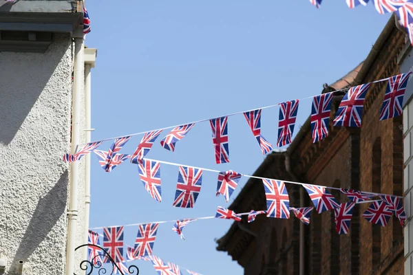 Union Jack flags hang in Windsor in preperation for the royal we — Stockfoto