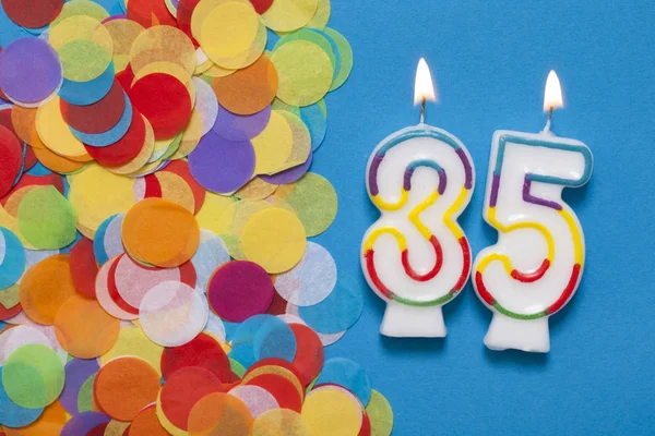 Number 35 celebration candle with party confetti — Stock Photo, Image