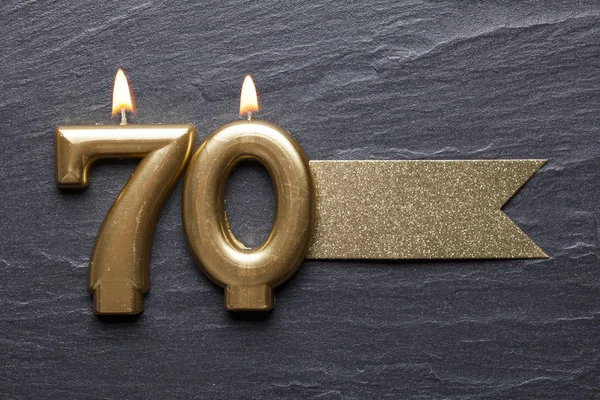 Parlak etiketli 70 numaralı kutlama mumu.
