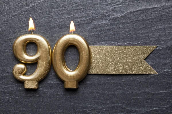 Gold number 90 celebration candle with glitter label — Stock Photo, Image