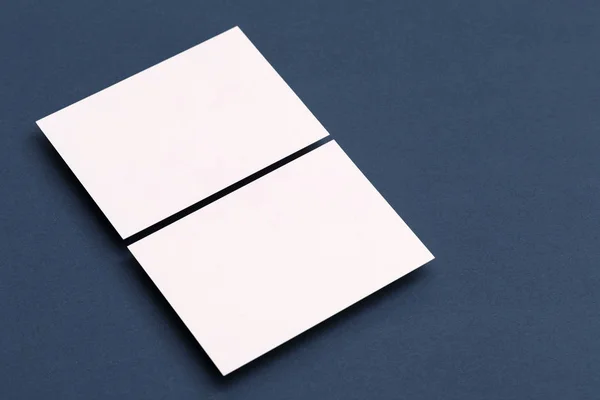 Blank white business card postcard flyer on a blue background Royalty Free Stock Images