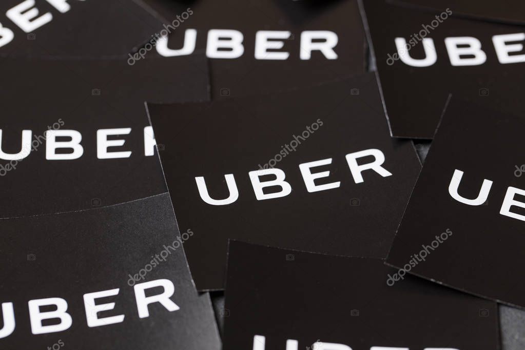 A photograph of  the Uber logo. Uber is a popular taxi style transport service application, founded in 2009