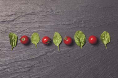 Kırmızı vişneli domates ve yeşil salata yaprakları.