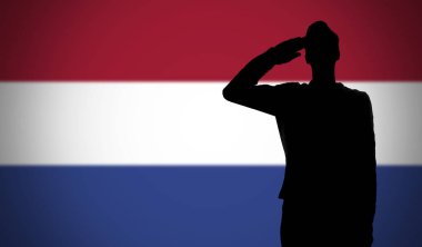 Hollanda bayrağına selam veren bir askerin silueti.