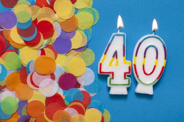 Number 40 celebration candle with party confetti — Stock Photo, Image