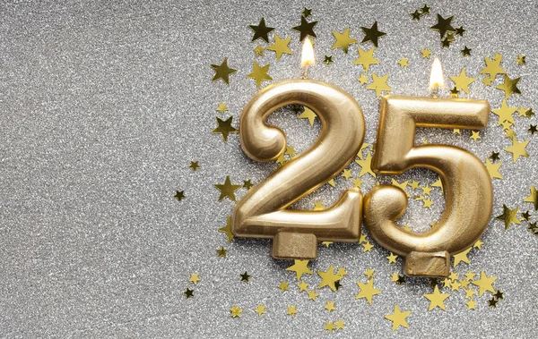 Number 25 gold celebration candle on star and glitter background — Stock Photo, Image