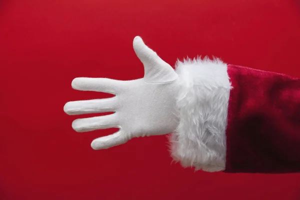 Santa Claus mano sobre un fondo rojo — Foto de Stock