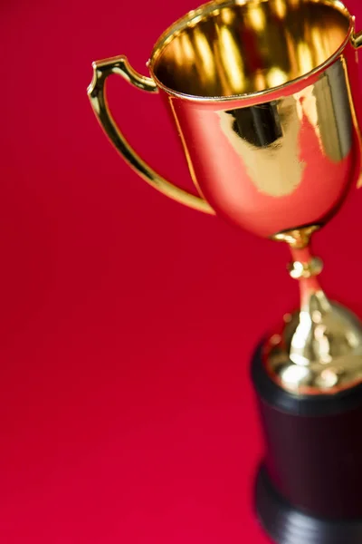 Gold winners trophy cup on a red background