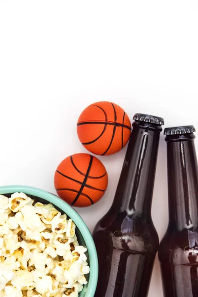 Baasketball match party. Beer bottle with basketball and popcorn
