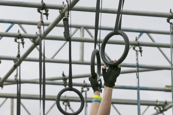 A person on hanging rings during an adventure obstacle course ra — Stock Photo, Image